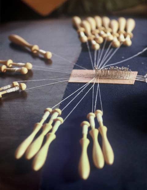 Wooden bobbins and pins for lace making.